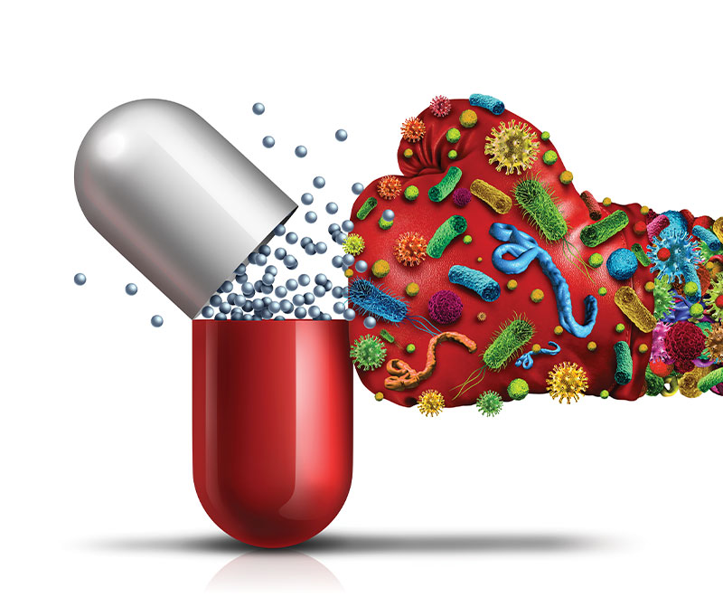 Illustration of a boxing glove covered in bacteria punching a medicine capsule