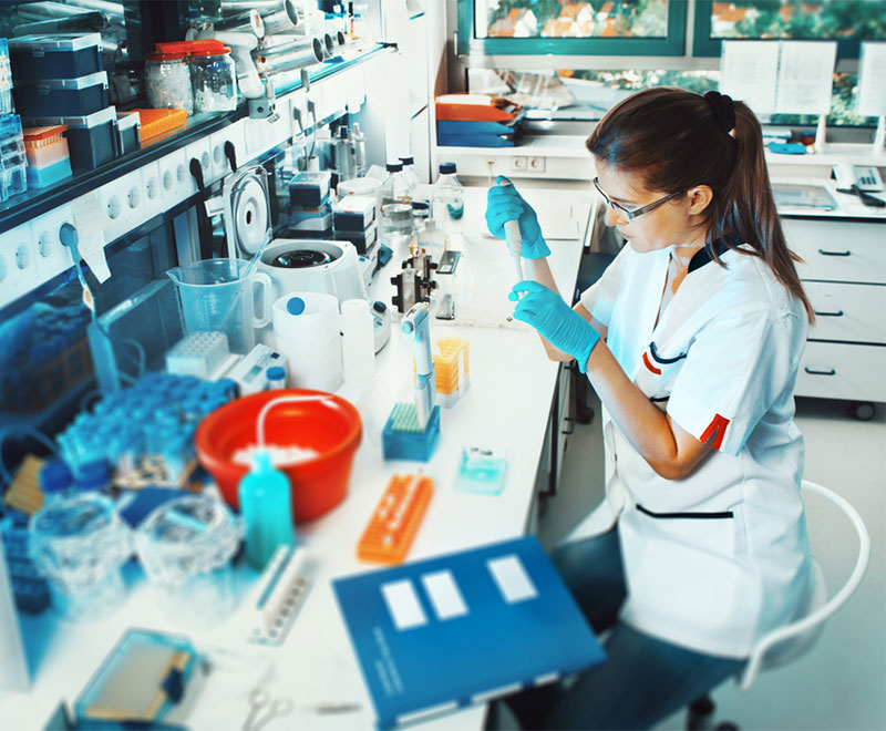 Photo of researcher putting specimen in a tube