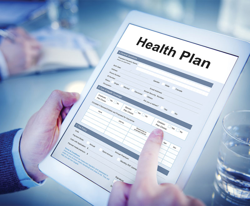 Photo of hands holding a tablet with Health Plan e-Forms