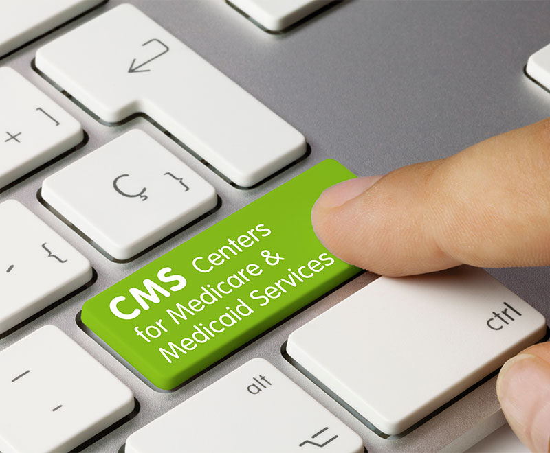 Photo of keyboard with human finger pushing an enter button that says "CMS Centers for Medicare & Medicaid Services"