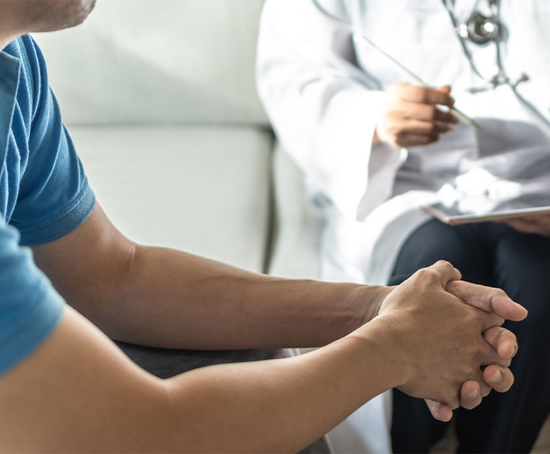 Photo of a male patient speaking with a doctor