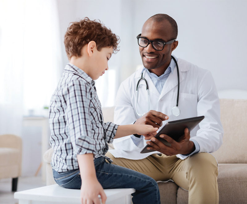 Photo of doctor talking with a pediatric patient