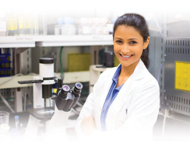 Medical researcher in lab with microscope