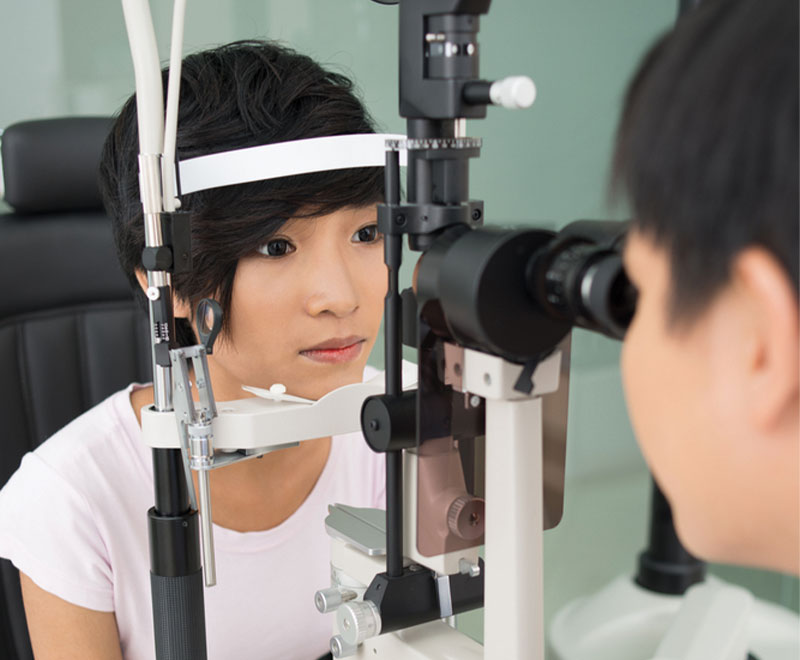 Photo of a young adult female patient receiving a glaucoma test