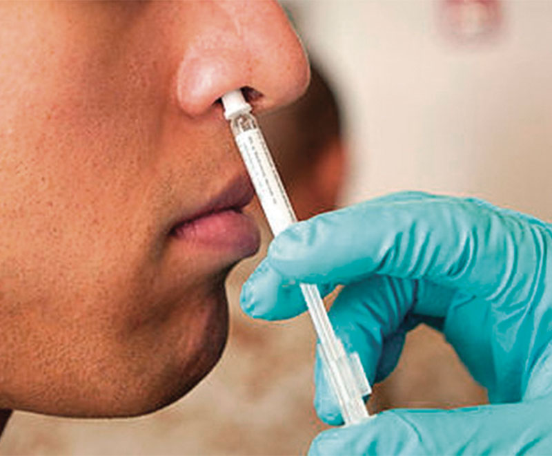 Photo of a patient receiving a nasal flu vaccine.