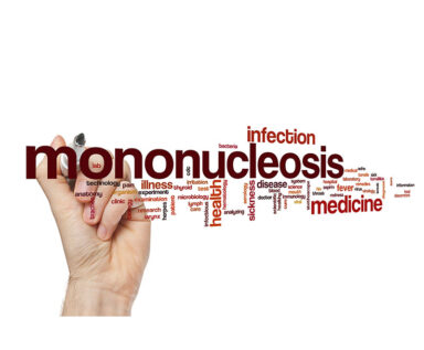 hand writing the word "mononucleosis"