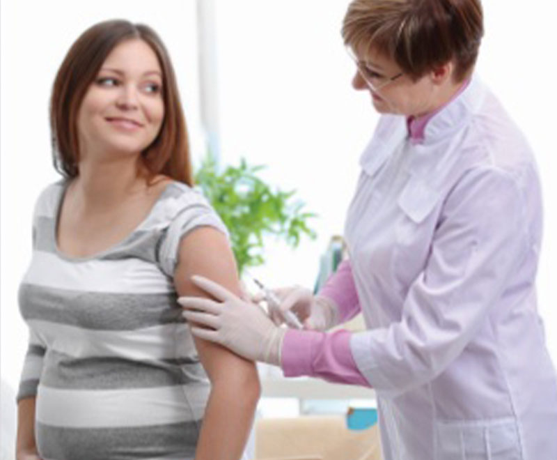 Photo of pregnant woman receiving a vaccine