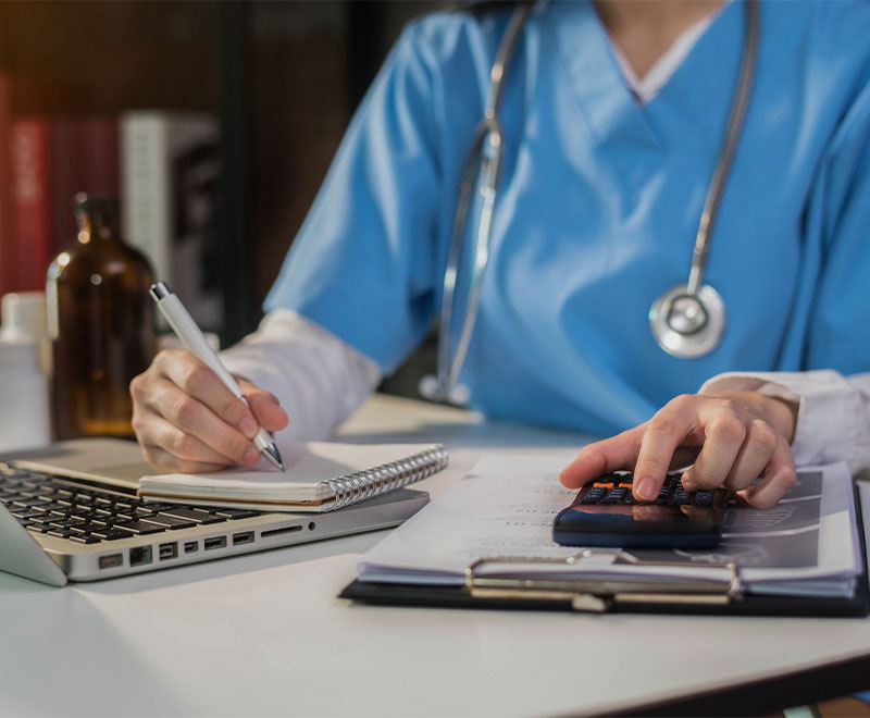 Photo of healthcare worker calculating a payment