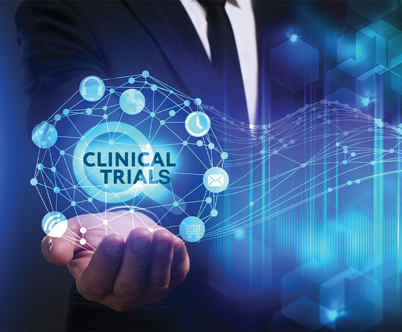 Illustration of a human hand holding text that says clinical trials