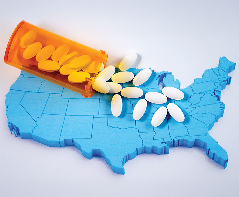 Image of a map of the United States with a medicine bottle pouring out white pills