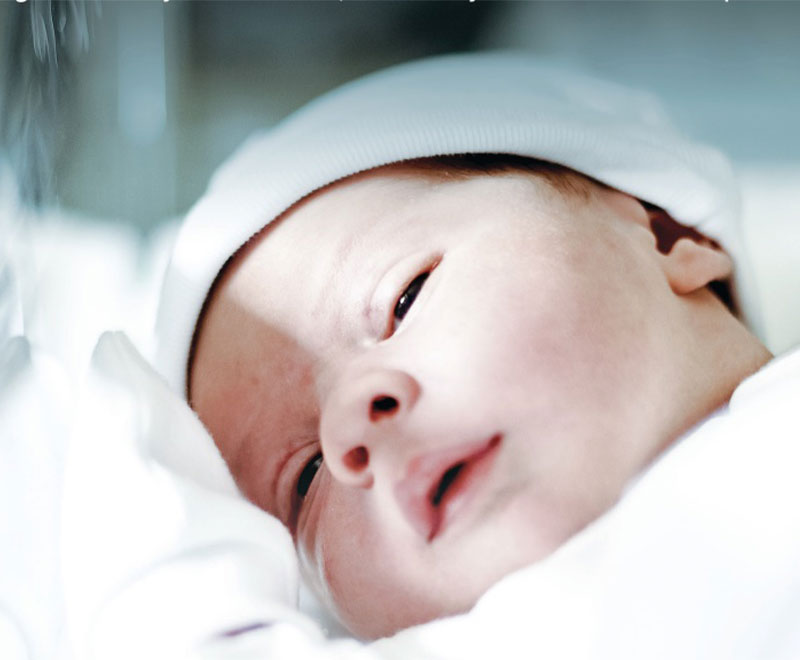 Photo of newborn in a hospital bed