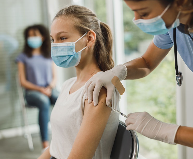 Photo of a teen girl receiving a vaccine