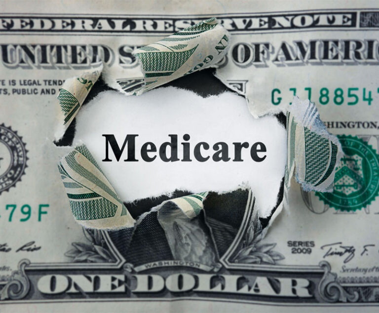 Image of a dollar bill torn in the middle, with the word "Medicare" in the middle