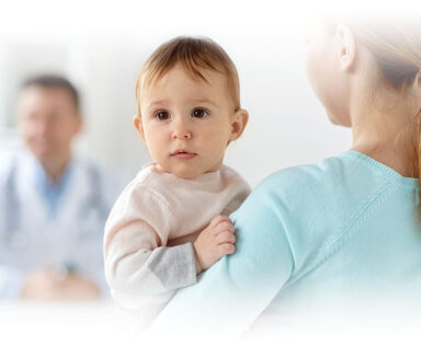 Photo of a mother holding a baby in a doctor's office