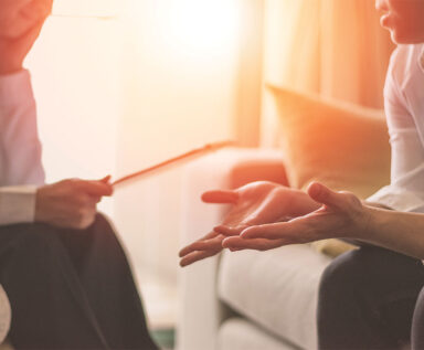 Photo of a care provider talking to a patient