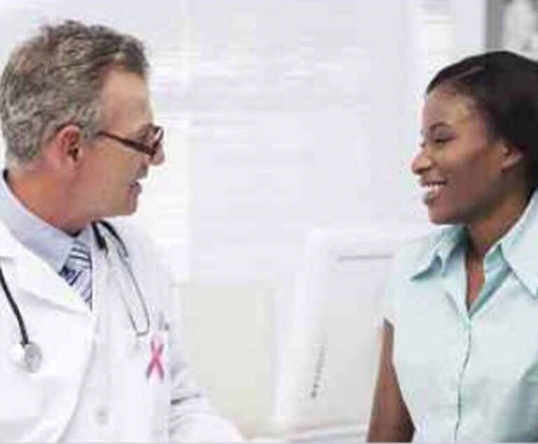 Photo of a male physician speaking with young woman
