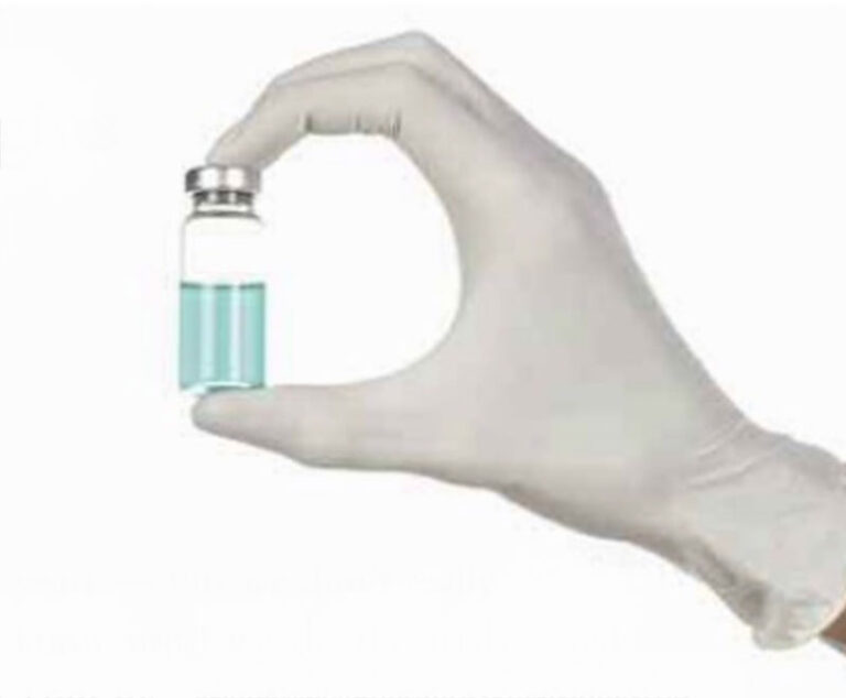 Image of a human hand holding a medicine vial