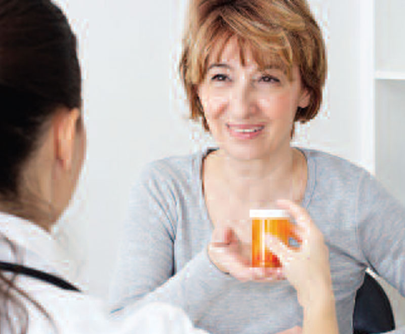 patient receiving prescription from pharmacist