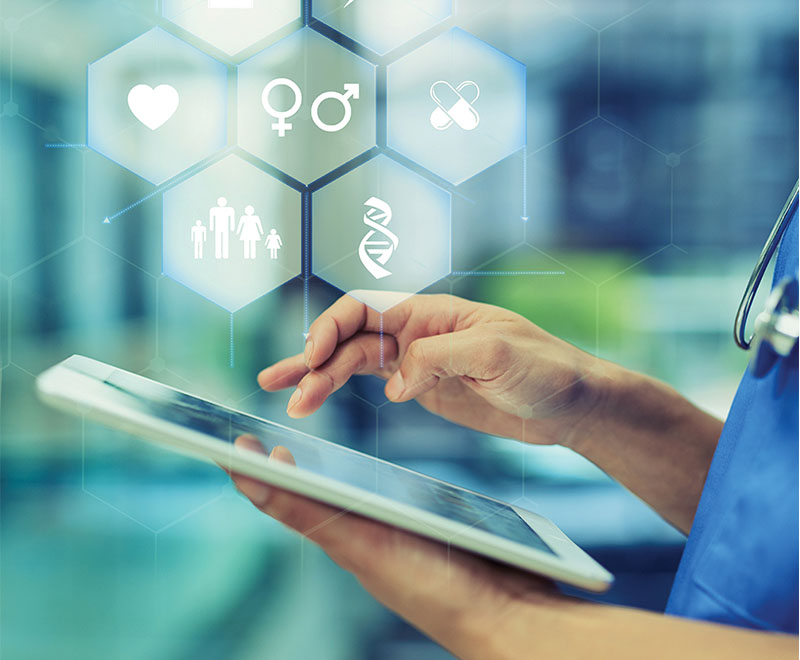 Medical provider in scrubs holding a tablet with medical concept art above.