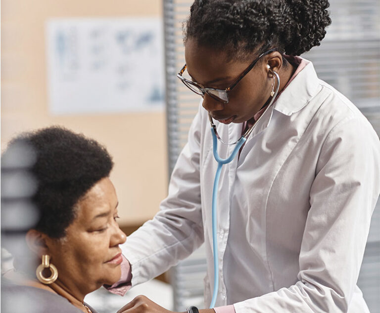 Doctor listening to a patient's heart with stethoscope.