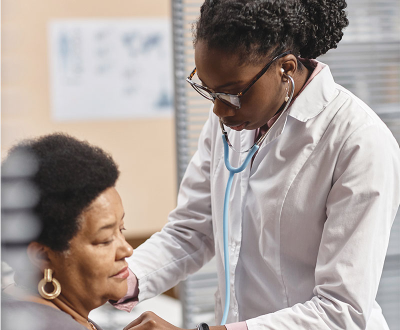 Doctor listening to a patient's heart with stethoscope.