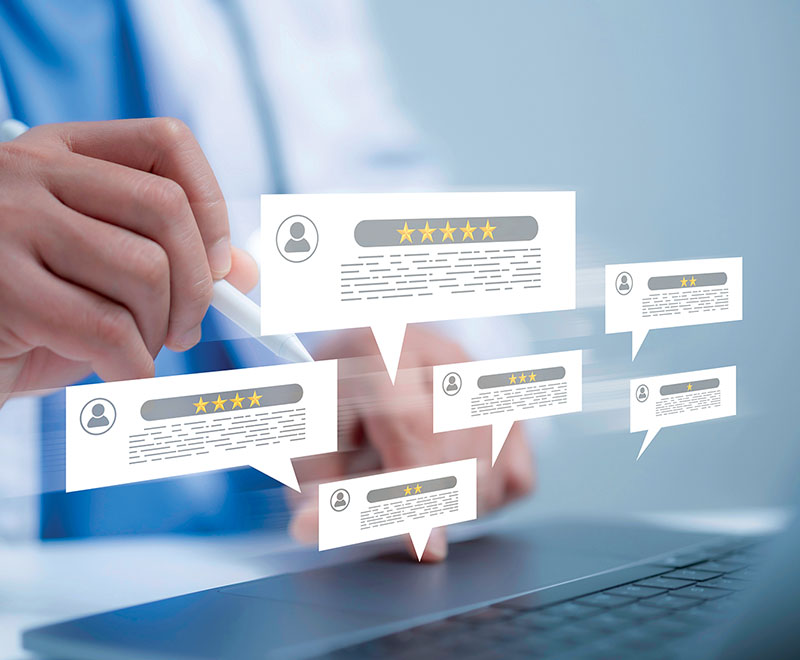 Medical practitioner seeing reviews appearing over a laptop keyboard..