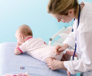 Doctor administering a vaccine to an infant.